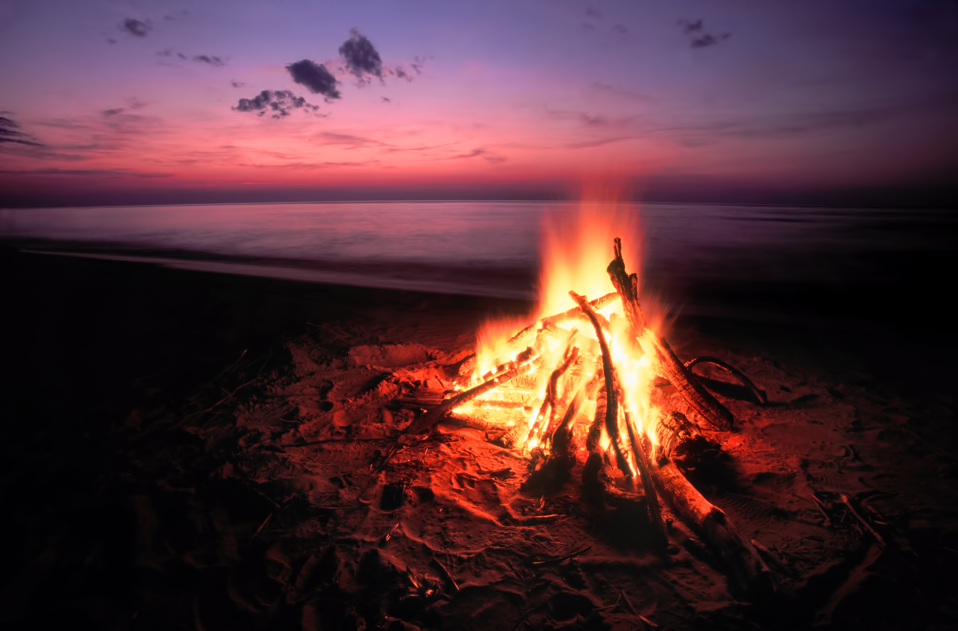 Bonfire on beach with sunset