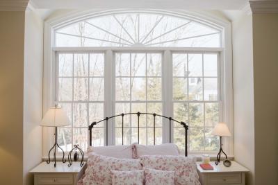 Windows can provide a magnificent backdrop for a bed.
