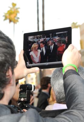 iPad user watching the TV show, The Office, on the device.